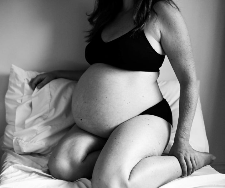 black and white image of a full term pregnant woman