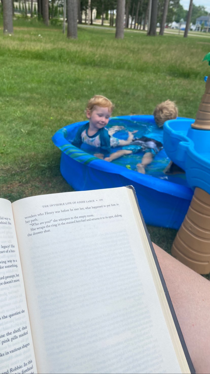 Page of a book while boys swim in pool