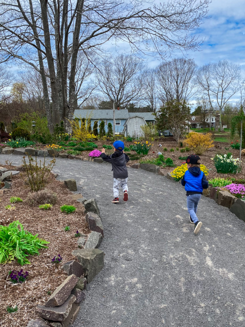 Two young kids run through the path in the gardens at Summerland nursery in Wilmont, Nova Scotia